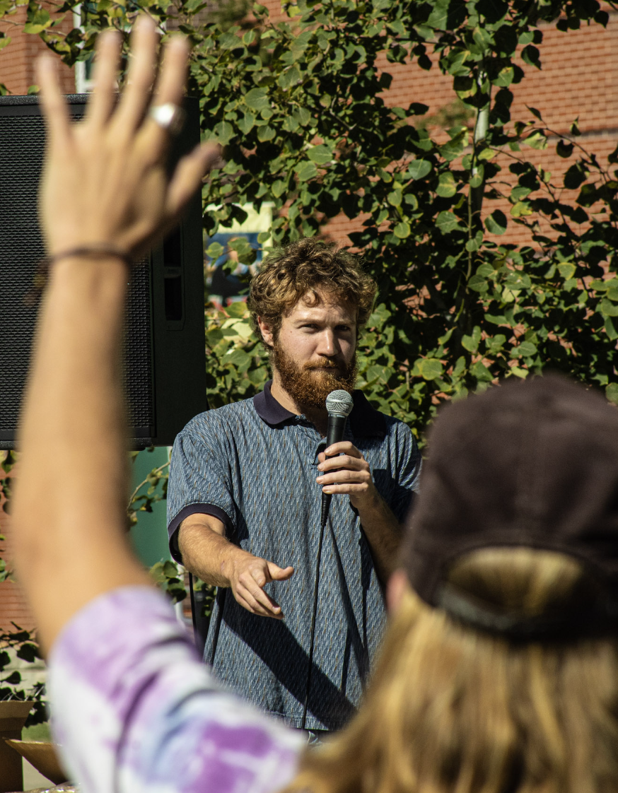 Tommy Hexter `21 speaks at a rally held at Commencement Stage at Grinnell College on Saturday, Sept. 7, 2024.